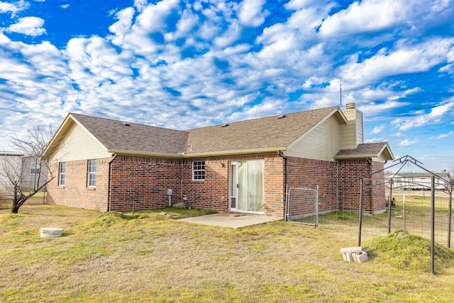 back of house featuring a yard and a patio