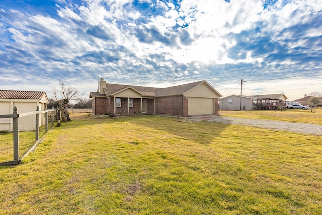 view of front of home featuring a garage and a front yard