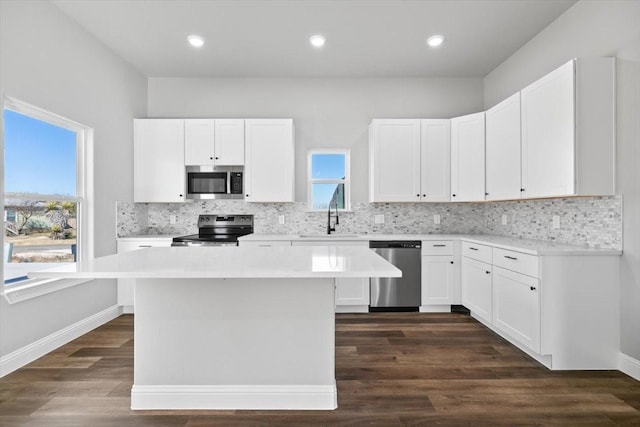 kitchen featuring white cabinetry, stainless steel appliances, and a center island