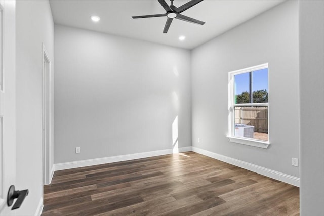 empty room with dark wood-type flooring and ceiling fan