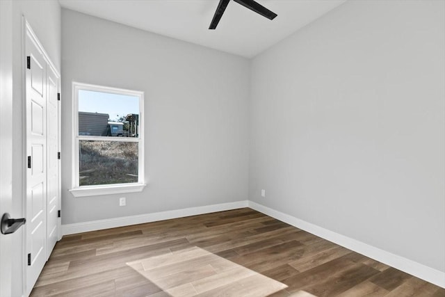 spare room with ceiling fan and wood-type flooring