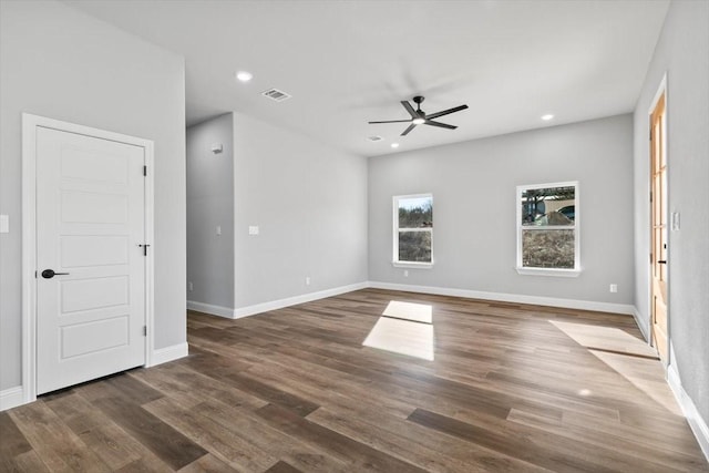 empty room featuring dark hardwood / wood-style floors and ceiling fan