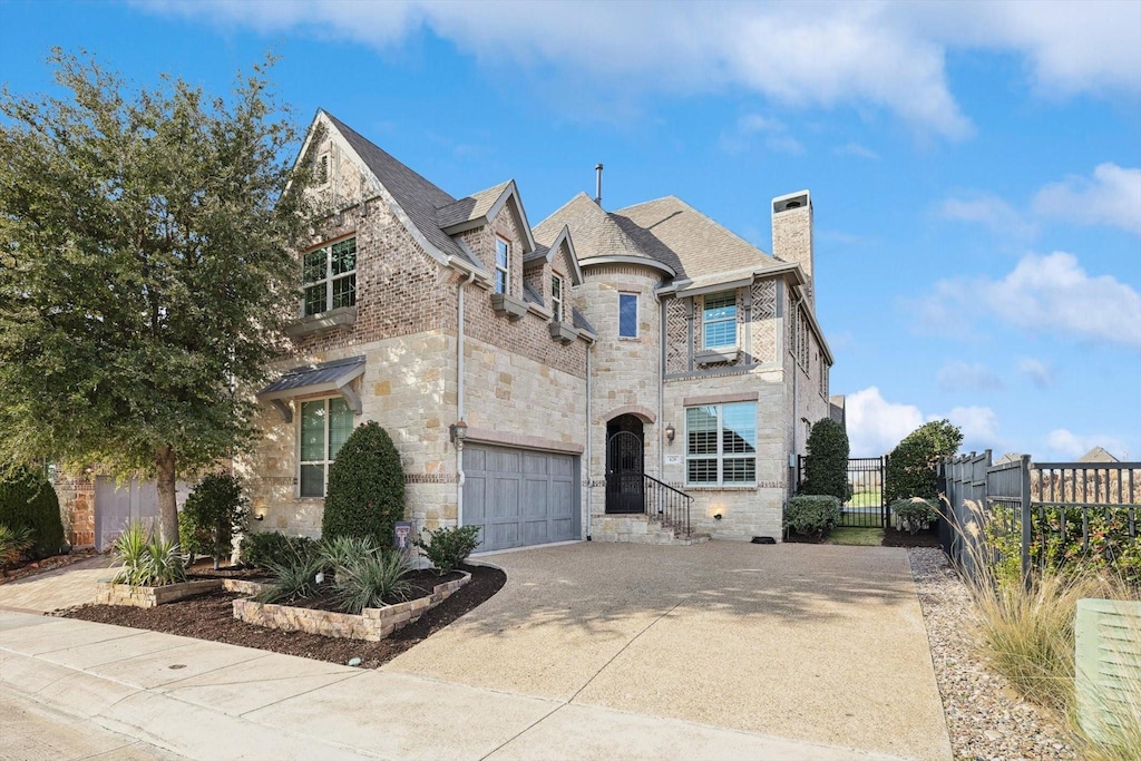 french country inspired facade featuring a garage