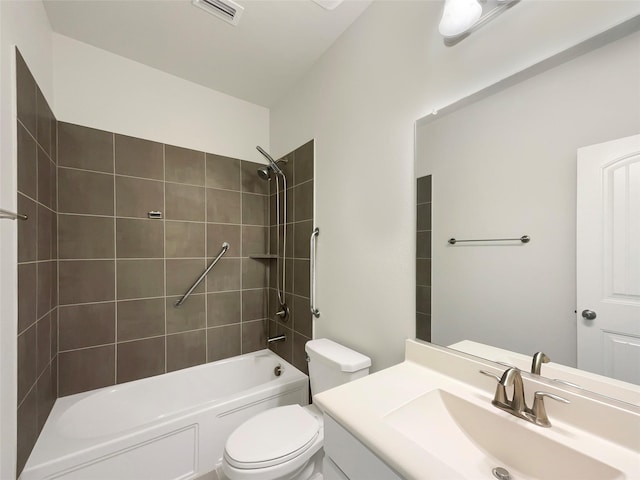 full bathroom featuring vanity, toilet, and tiled shower / bath