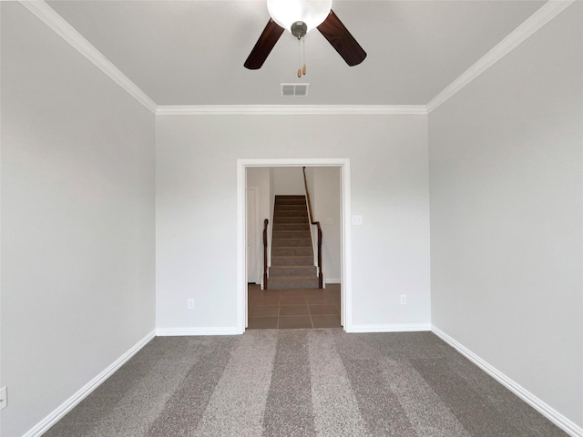 empty room featuring ornamental molding, ceiling fan, and carpet