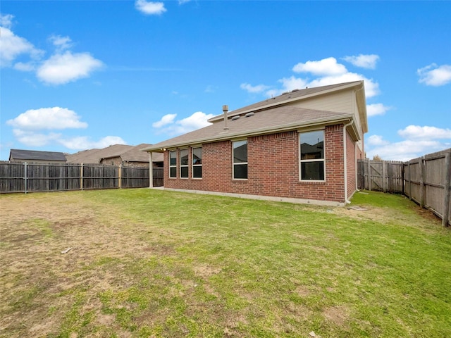 back of house featuring a yard