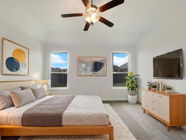 bedroom featuring ceiling fan, lofted ceiling, carpet flooring, and multiple windows