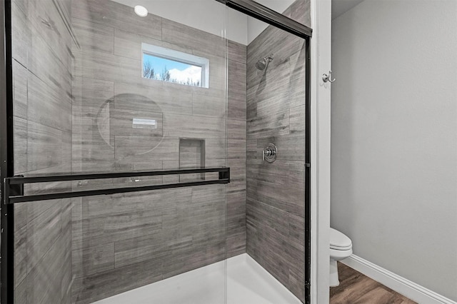 bathroom featuring an enclosed shower and toilet