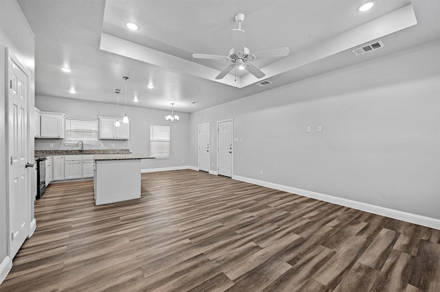 kitchen featuring white cabinetry, dark hardwood / wood-style floors, decorative light fixtures, and a center island