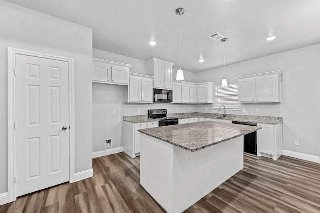 kitchen featuring black appliances, a kitchen island, stone counters, pendant lighting, and white cabinets