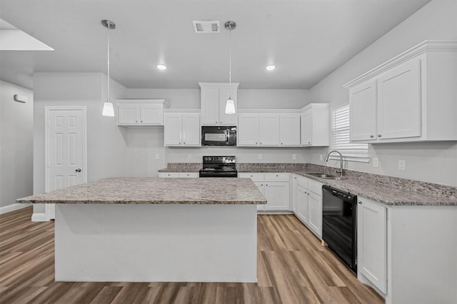 kitchen featuring sink, decorative light fixtures, black appliances, and white cabinets