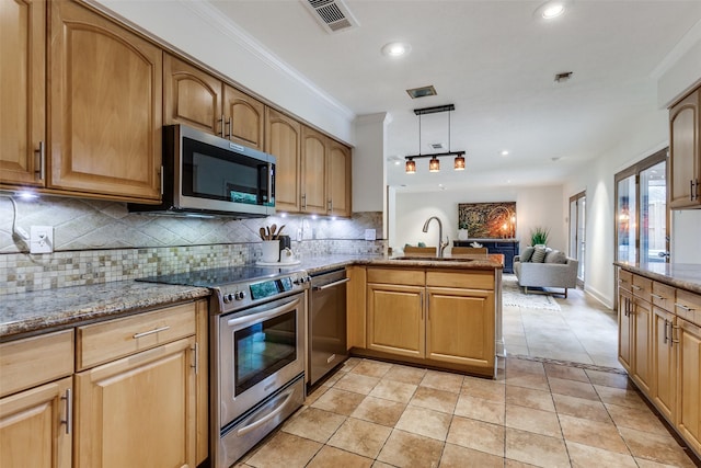 kitchen with tasteful backsplash, sink, hanging light fixtures, light tile patterned floors, and stainless steel appliances