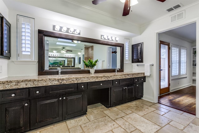 bathroom featuring vanity, crown molding, and ceiling fan