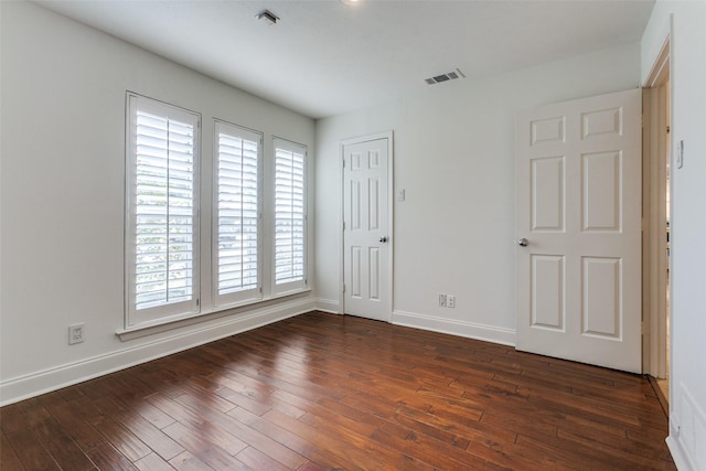 spare room with dark wood-type flooring