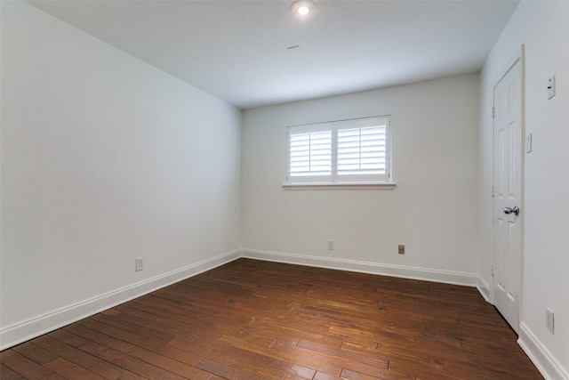 spare room featuring dark hardwood / wood-style flooring