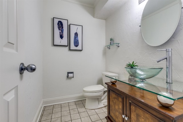 bathroom with vanity, tile patterned flooring, ornamental molding, and toilet