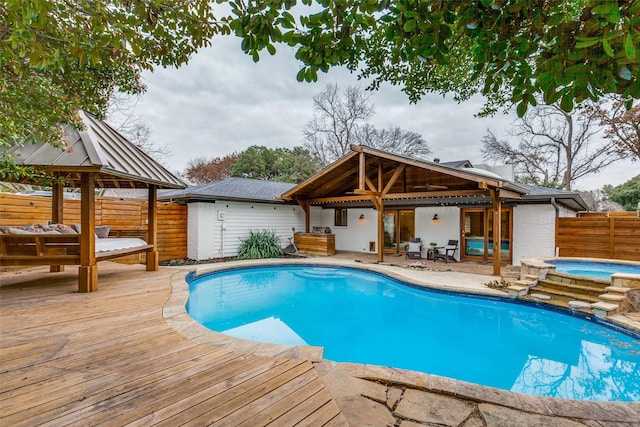 view of swimming pool with a gazebo, a deck, and an in ground hot tub