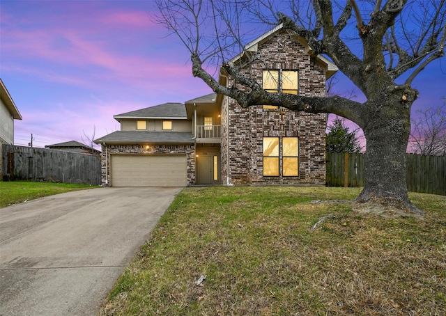 view of property with a balcony, a garage, and a yard