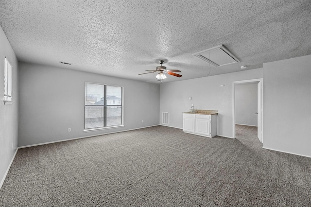 unfurnished living room with carpet flooring and ceiling fan