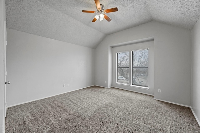 bonus room with carpet floors, a textured ceiling, vaulted ceiling, and ceiling fan