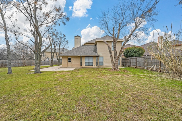 rear view of property with a yard and a patio