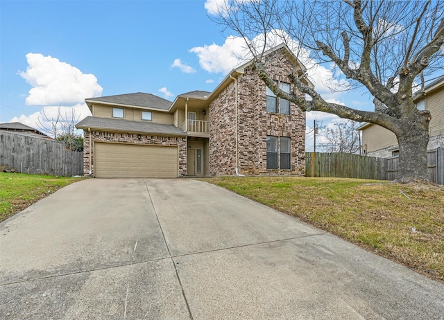 view of property featuring a garage, a balcony, and a front yard