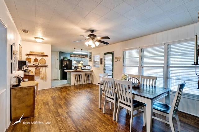 dining space with dark wood-type flooring and ceiling fan