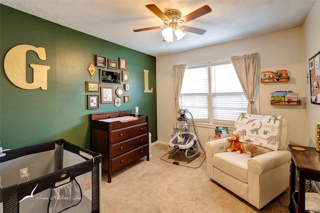 carpeted bedroom with ceiling fan and a textured ceiling