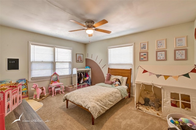 bedroom with multiple windows, ceiling fan, and carpet flooring