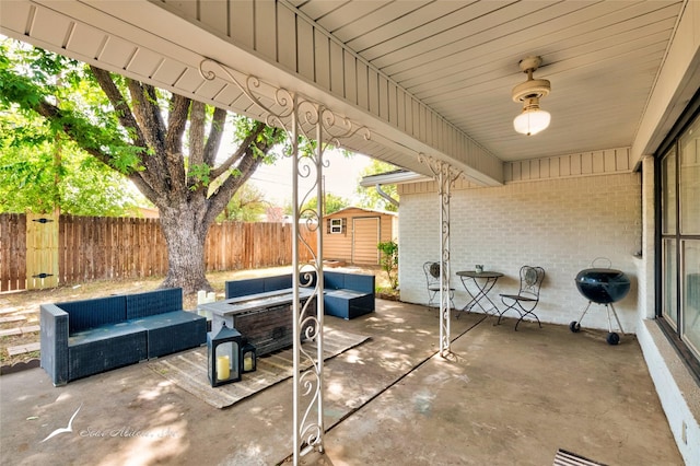 view of patio featuring an outdoor living space, a storage unit, and a grill