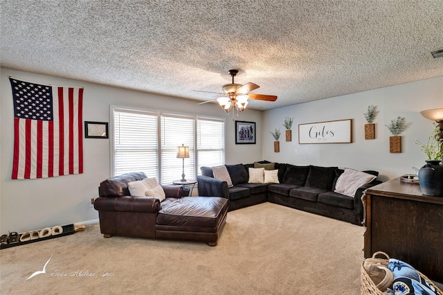 carpeted living room featuring ceiling fan and a textured ceiling