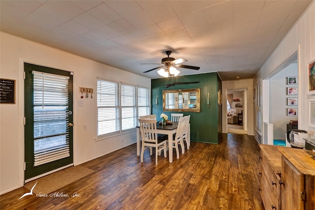 dining area featuring ceiling fan and dark hardwood / wood-style flooring