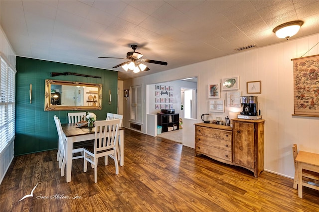 dining space with a wealth of natural light, dark wood-type flooring, and ceiling fan