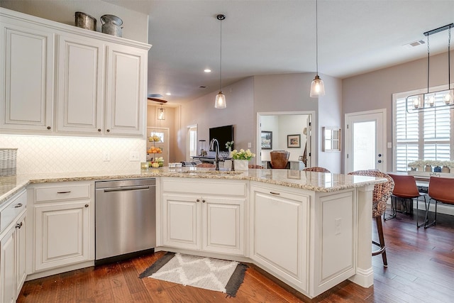 kitchen featuring pendant lighting, tasteful backsplash, sink, stainless steel dishwasher, and kitchen peninsula