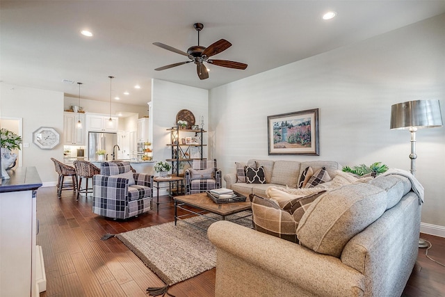 living room featuring dark hardwood / wood-style floors and ceiling fan