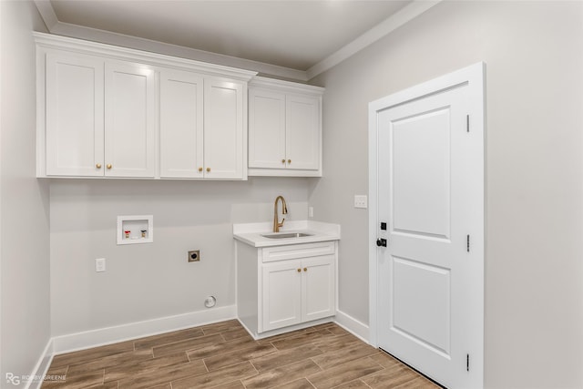 laundry area with cabinets, hookup for an electric dryer, hookup for a washing machine, and sink