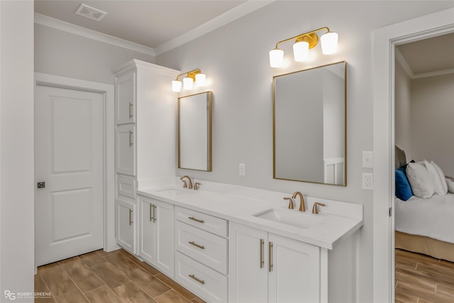 bathroom featuring crown molding and vanity