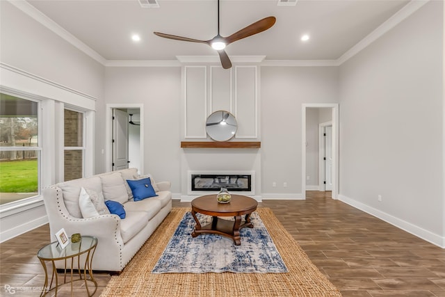 living room with ornamental molding, a large fireplace, and ceiling fan