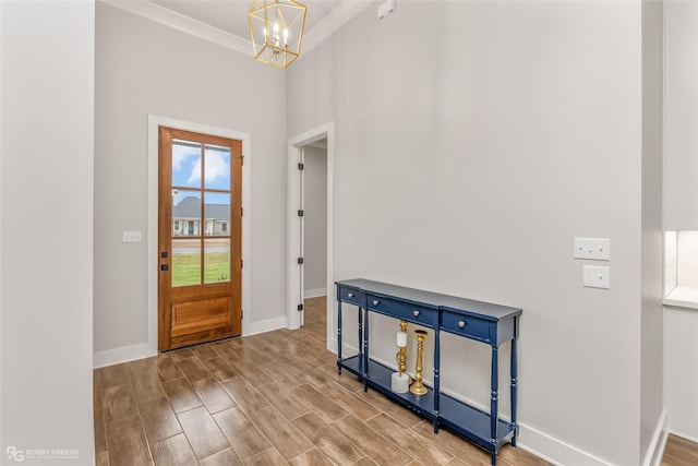 entryway featuring crown molding and a chandelier