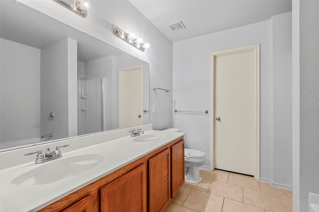 bathroom featuring tile patterned floors, toilet, vanity, and a shower