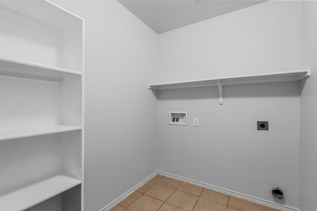 washroom with electric dryer hookup, washer hookup, and light tile patterned floors