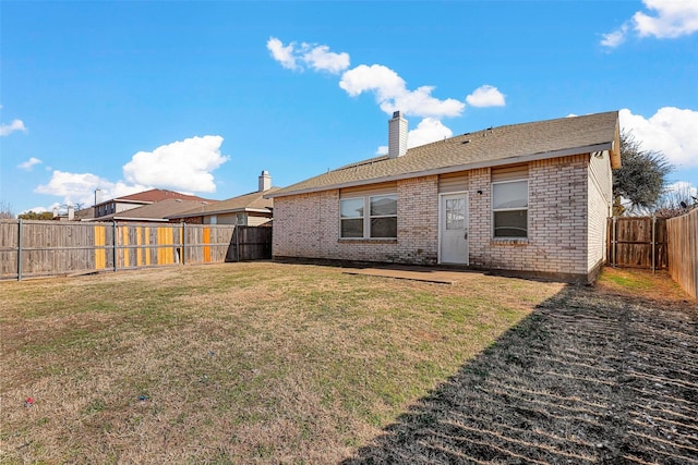 back of house featuring a yard