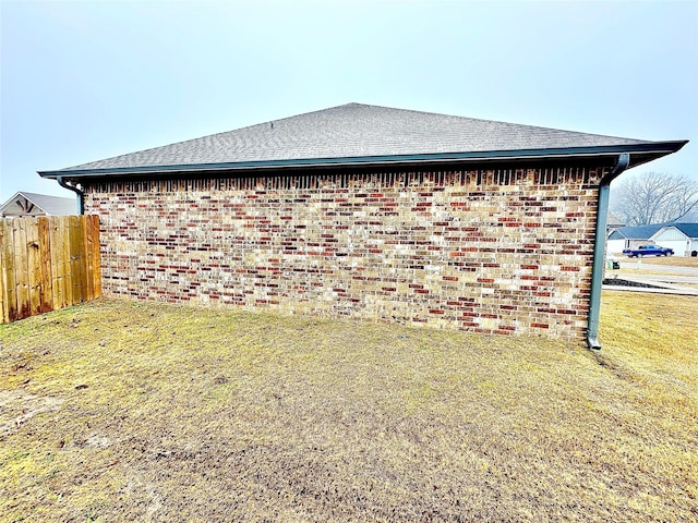 view of side of home with a yard