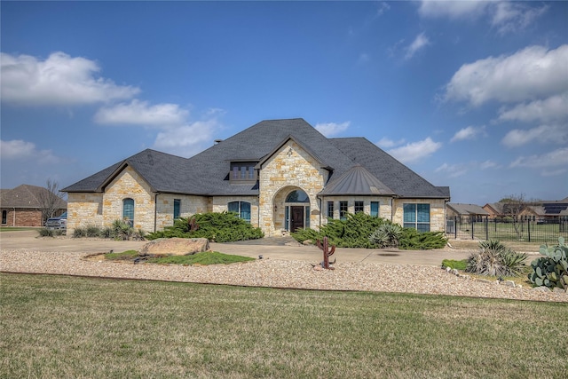 french country inspired facade with a front lawn