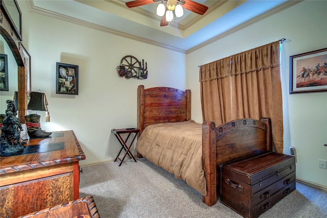 bedroom with light carpet, a tray ceiling, ornamental molding, and ceiling fan