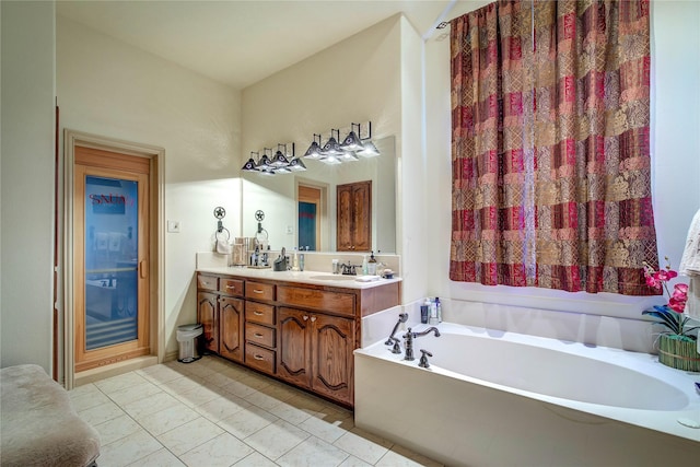 bathroom with tile patterned flooring, vanity, and a tub to relax in