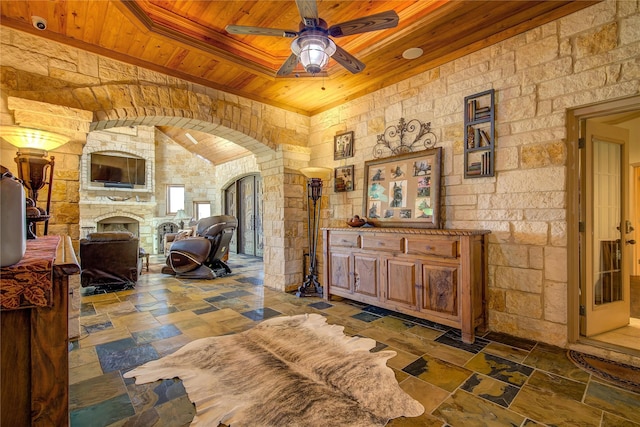 interior space featuring wood ceiling, a fireplace, and ceiling fan