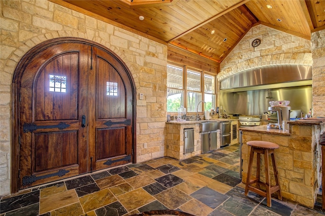 kitchen with vaulted ceiling and wooden ceiling