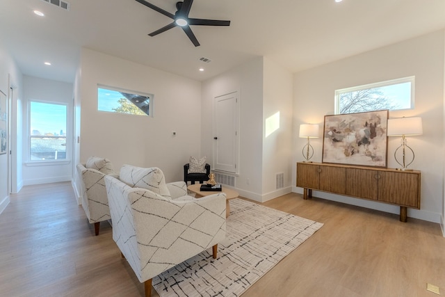 living room featuring ceiling fan and light hardwood / wood-style flooring