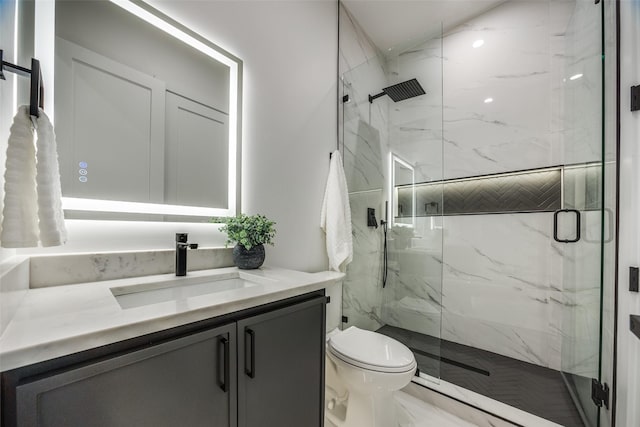 bathroom with vanity, walk in shower, and toilet